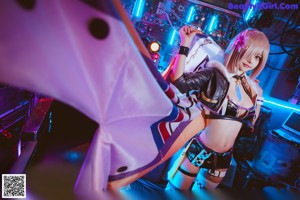 A woman in a black and white outfit holding an umbrella.