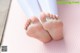 A close up of a person's bare feet on a pink mat.