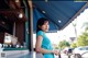 A woman standing at a counter in front of a restaurant.