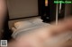 A bed with white sheets and pillows in a hotel room.